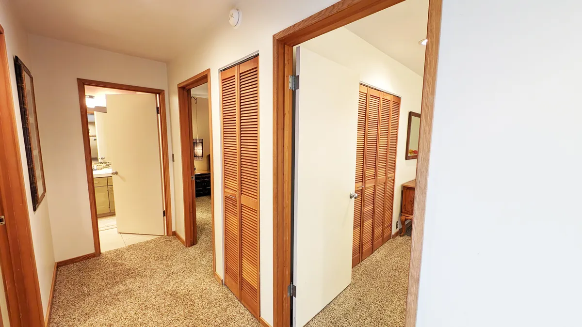 This image captures open doors framed by textured walls and warm wood trim, inviting views of adjacent rooms and highlighting the sense of flow and accessibility in the home. The openness suggests easy transitions from indoor to outdoor activities, aligning with the active and social vacation experience described in the section.